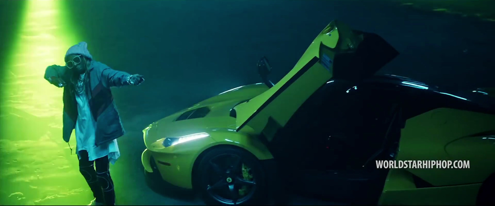 a man standing next to a yellow sports car