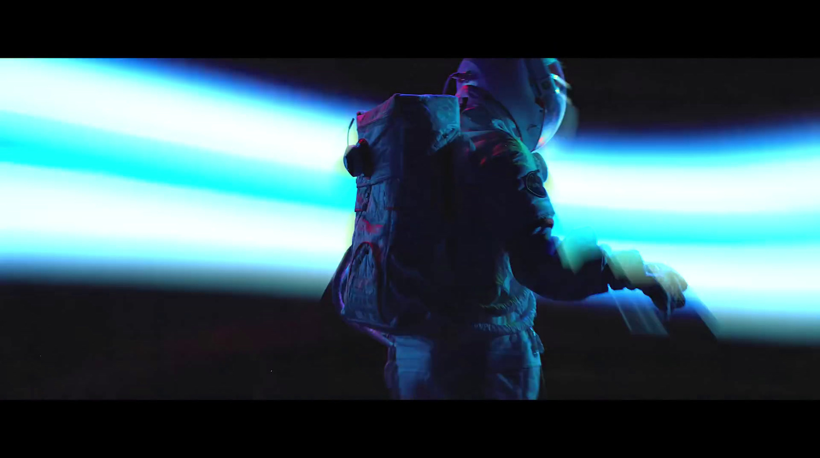 a man standing in front of a blue light