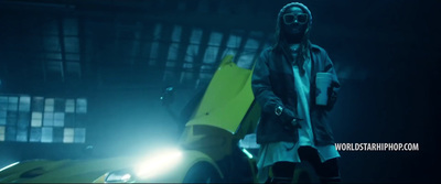 a man standing next to a yellow car in the dark