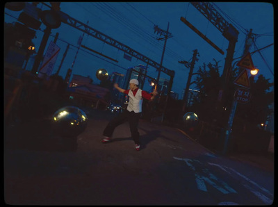 a person crossing a street at night with an umbrella