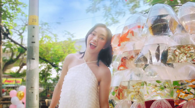 a woman in a white dress standing in front of a store display