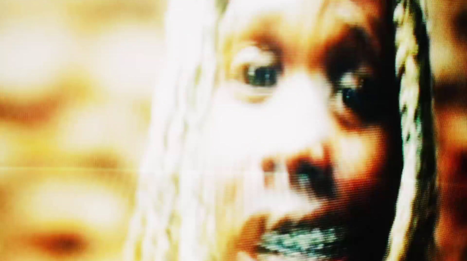 a blurry image of a woman's face with long hair