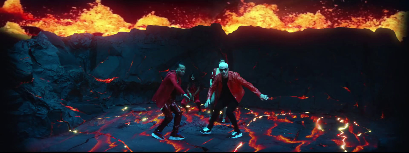 a group of people standing in front of a volcano