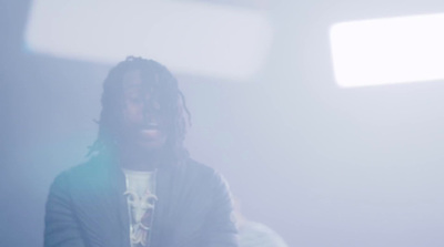 a man with dreadlocks standing in a room