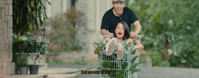 a man pushing a child in a shopping cart