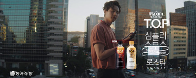 a man holding a bottle of liquor in front of a cityscape