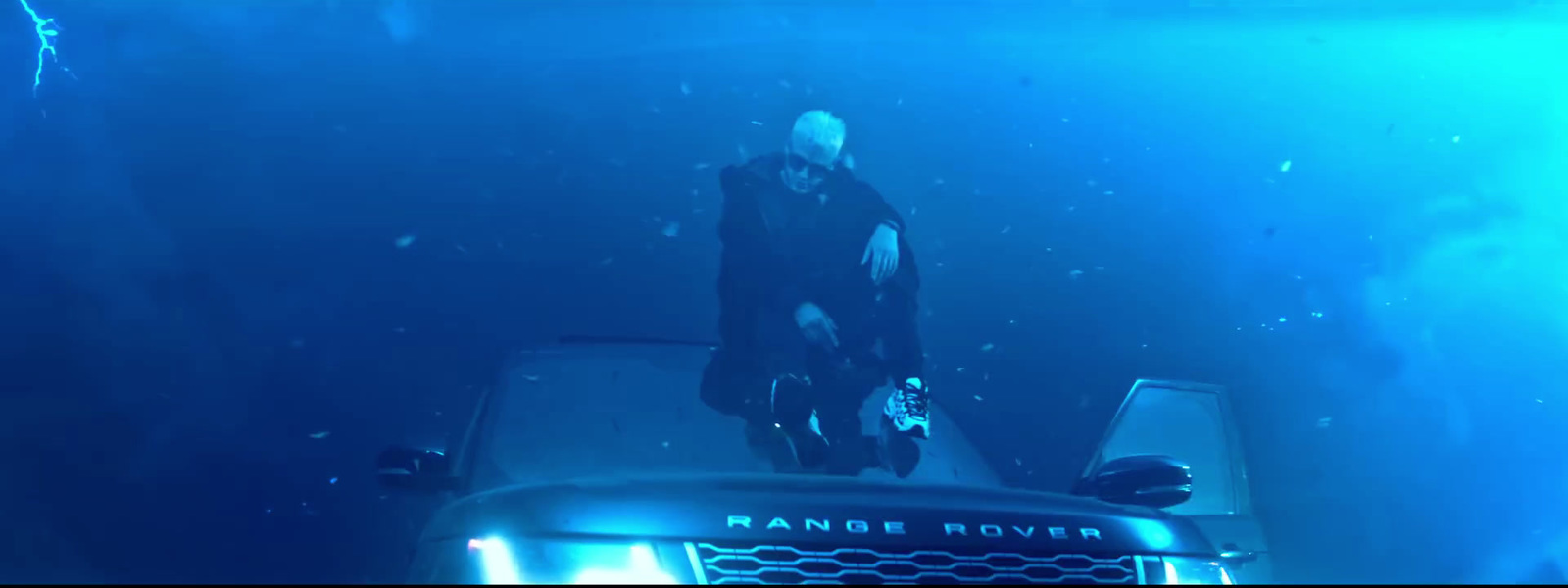 a man standing on top of a truck under water