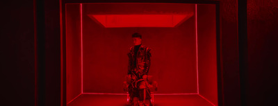 a person standing in a room with a red light