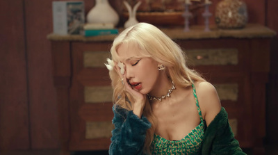 a woman in a green dress sitting down