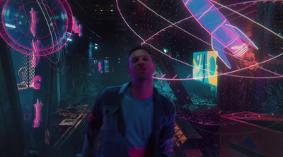 a man standing in a room with neon lights