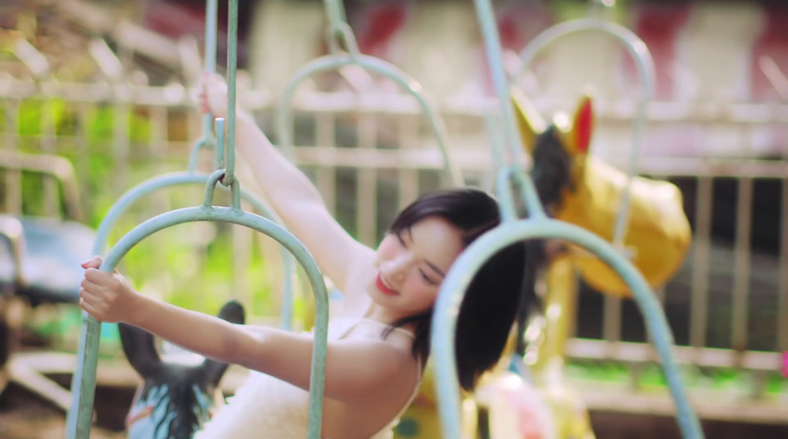 a woman is on a swing at a carnival