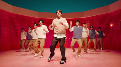 a group of young men standing on top of a pink floor