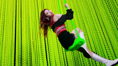 a woman standing in front of a green wall