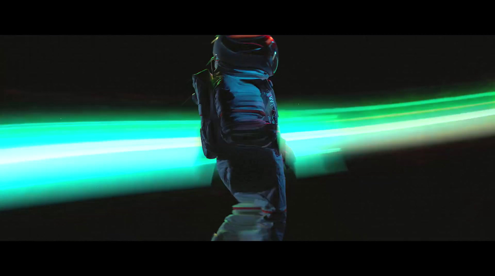 a man in a space suit standing in the dark