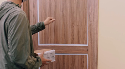 a man standing in front of a wooden door