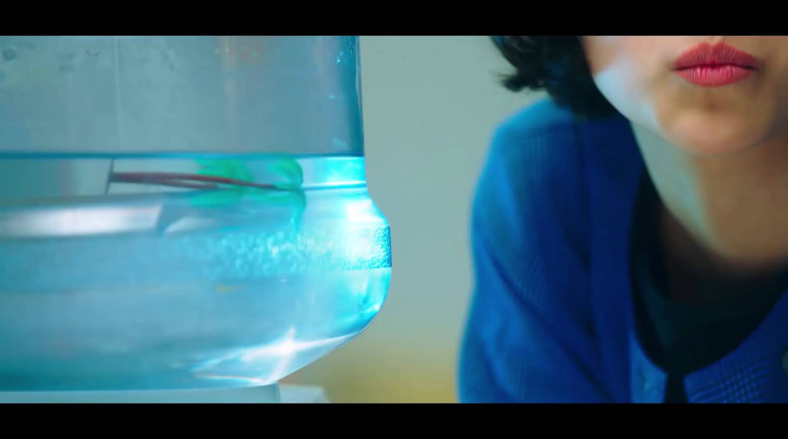 a close up of a person near a water container