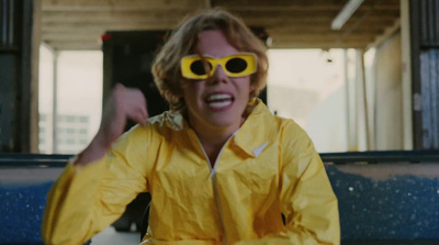 a woman in a yellow rain coat and yellow sunglasses