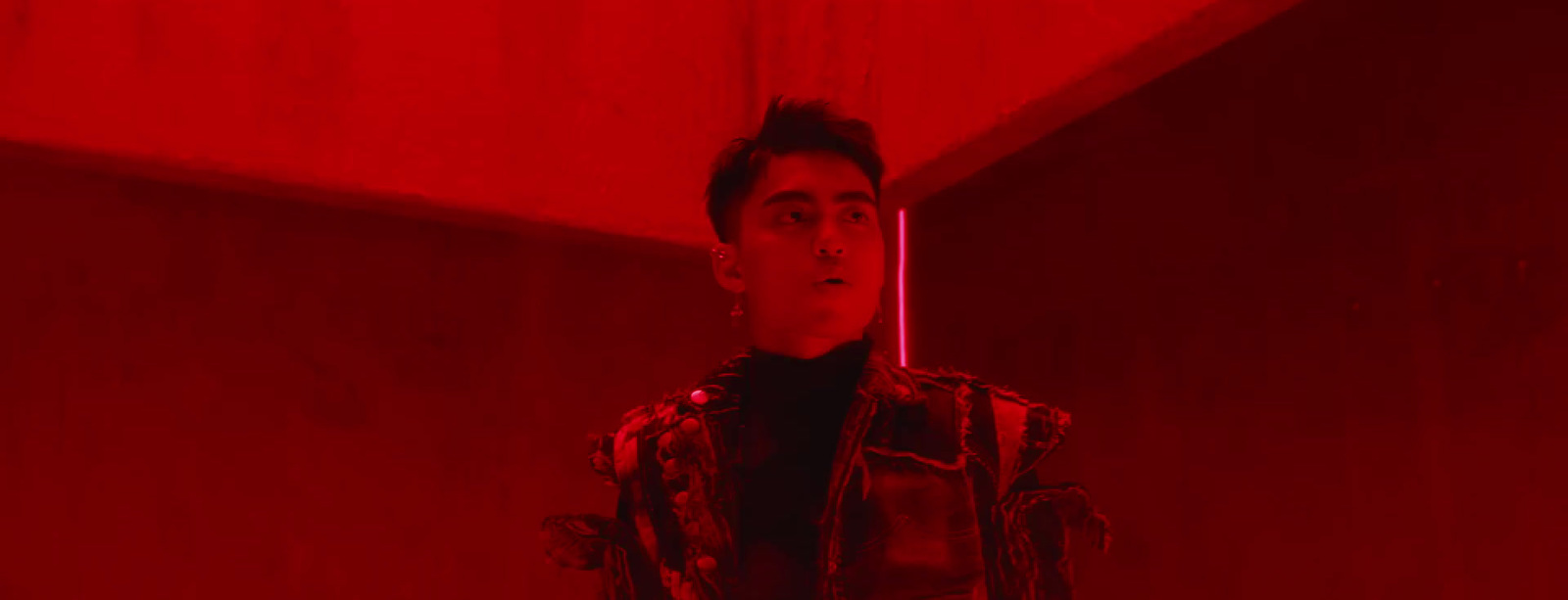 a man standing in a room with a red light