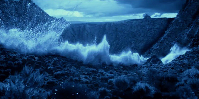 a large body of water near a mountain