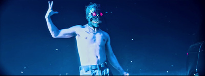 a shirtless man with a weird mask on