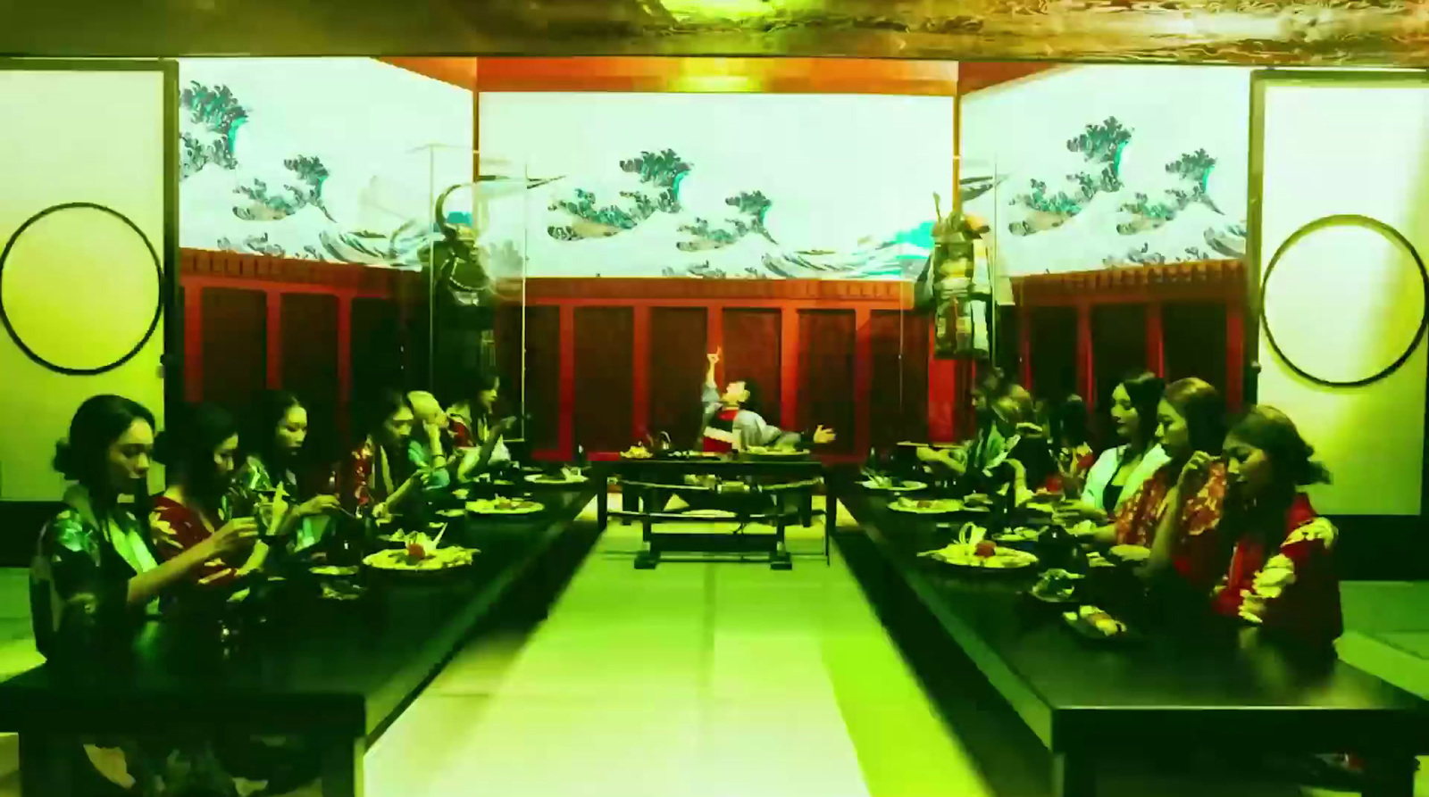 a group of people sitting at a long table