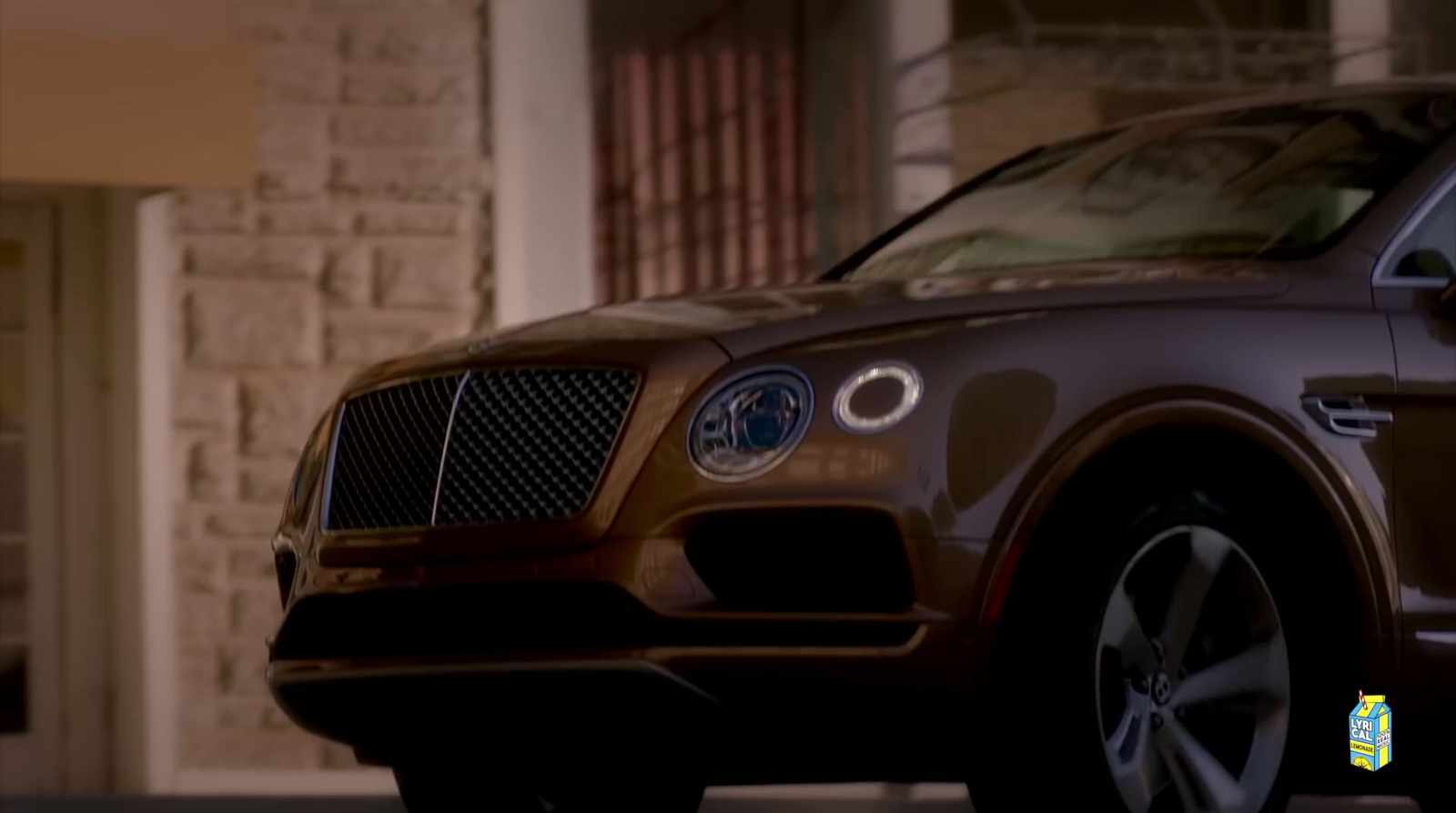 a brown car parked in front of a building