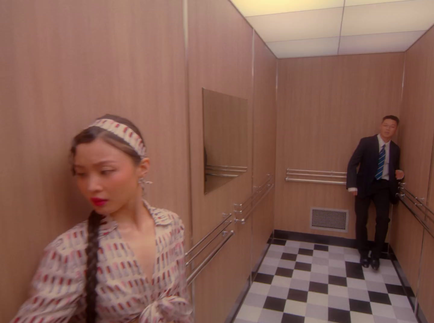 a man and a woman walking down a hallway