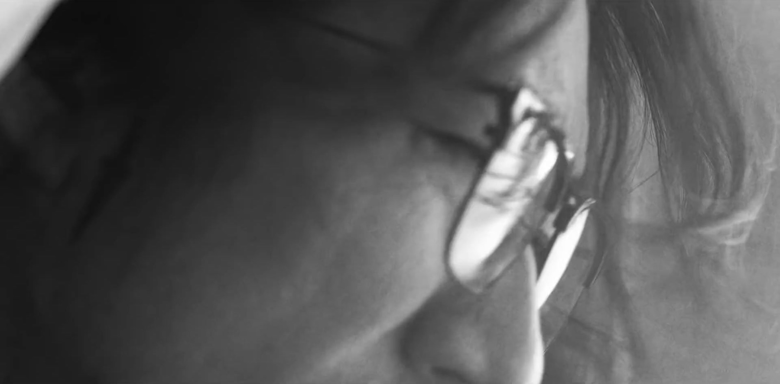 a close up of a person wearing glasses