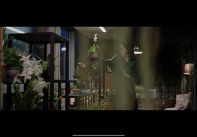 a woman standing in a living room next to a table