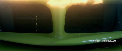 a close up of the front of a green sports car