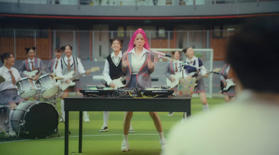 a woman with pink hair is playing a musical instrument