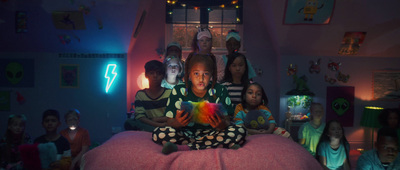 a group of children sitting on top of a bed