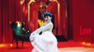 a woman in a white dress standing in front of a piano