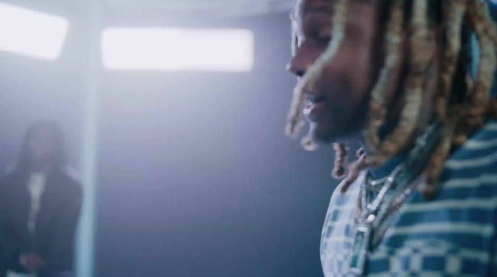 a man with dreadlocks standing in a room