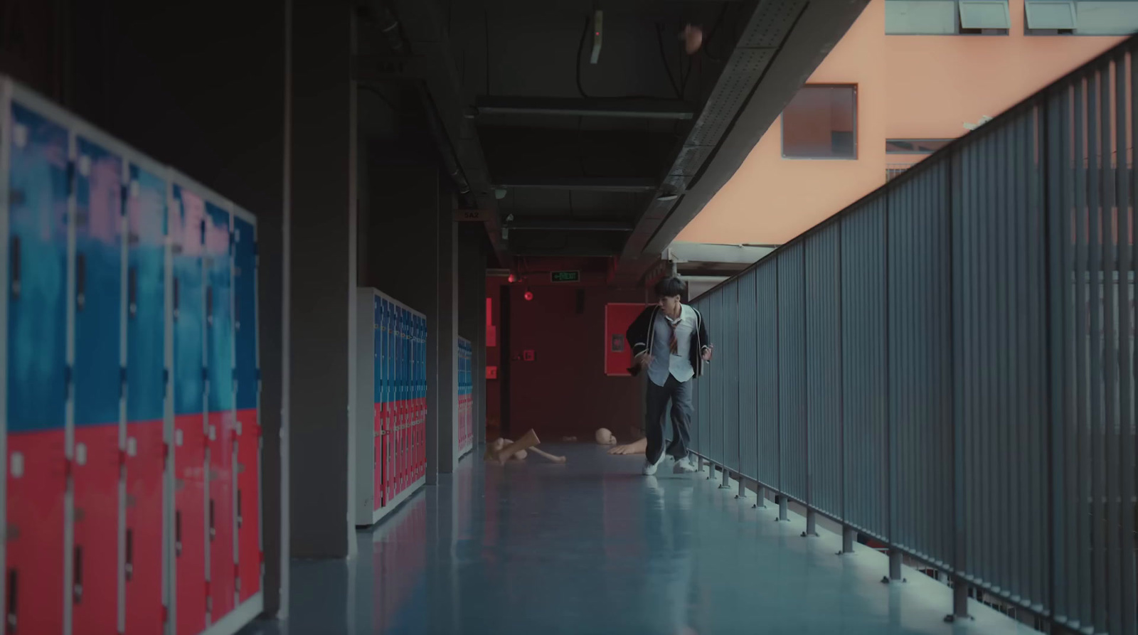 a man walking down a hallway in a building