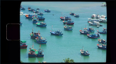 a group of boats floating on top of a body of water