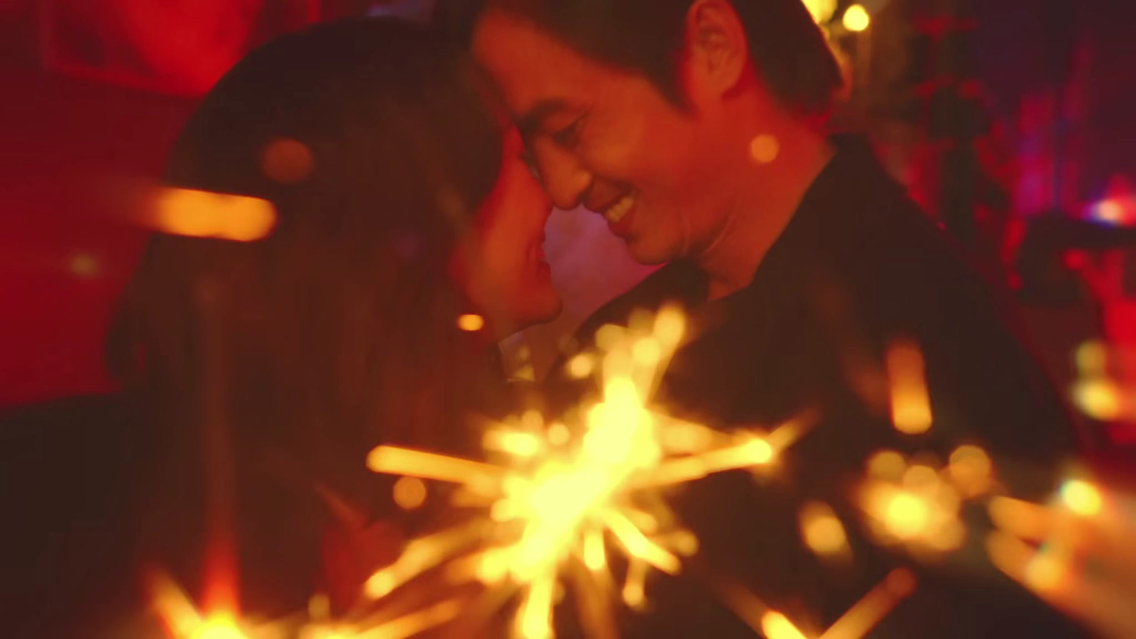 a man sitting in front of a firework