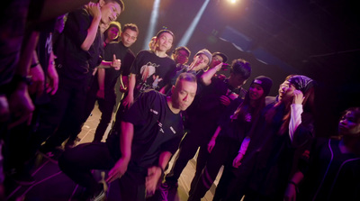 a group of people standing on top of a dance floor