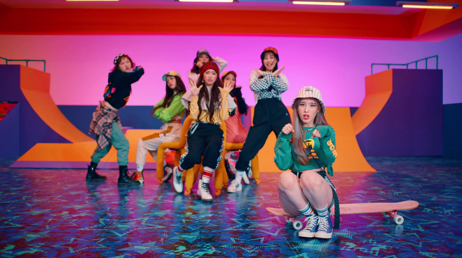 a group of young women riding skateboards on top of a blue floor