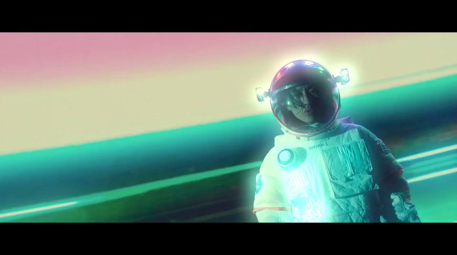 a man in a space suit standing in front of a colorful background