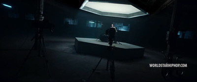 a man standing on top of a table in a dark room