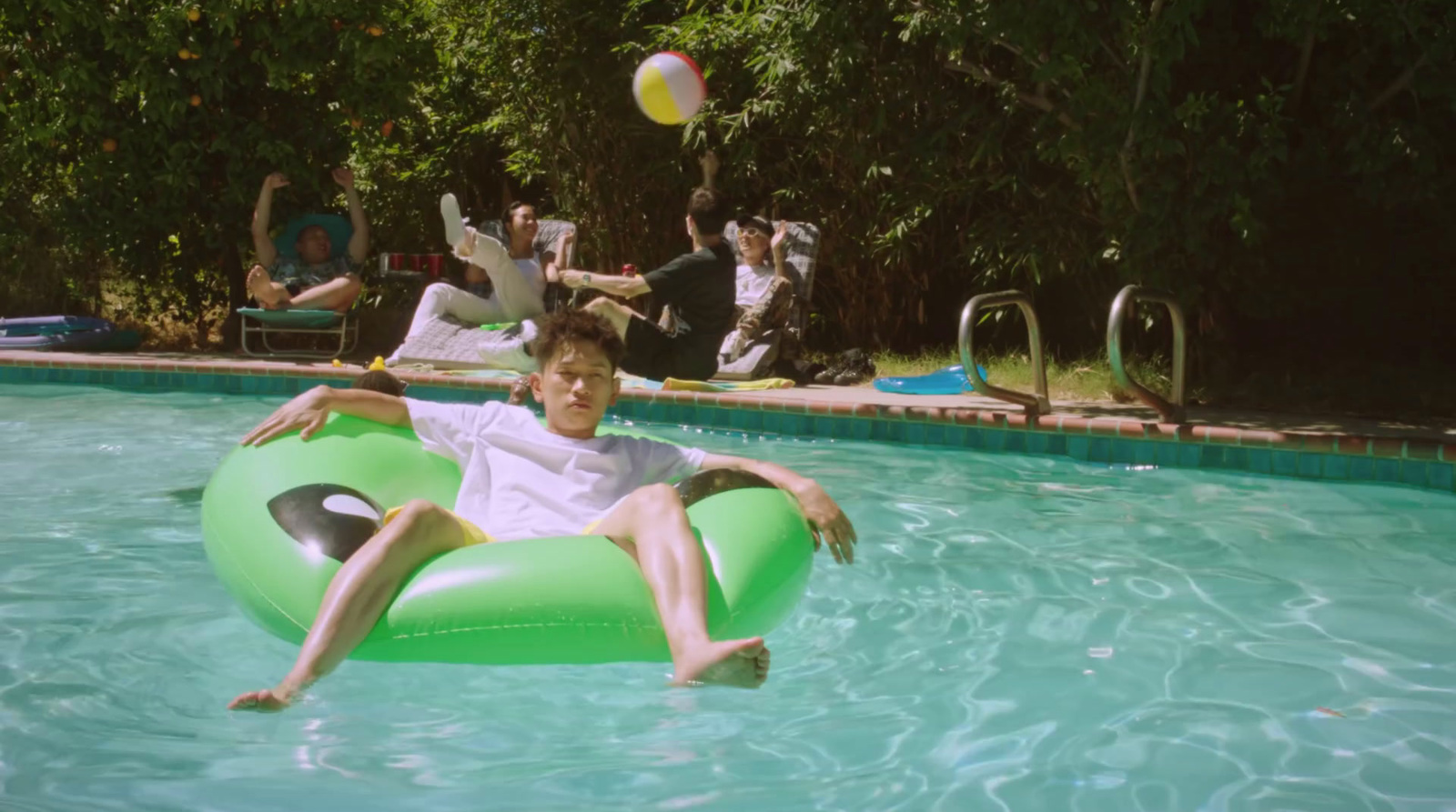 a boy is floating on an inflatable raft in a pool