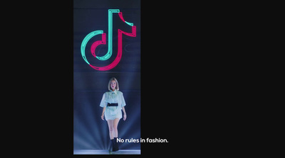 a woman standing in front of a neon sign