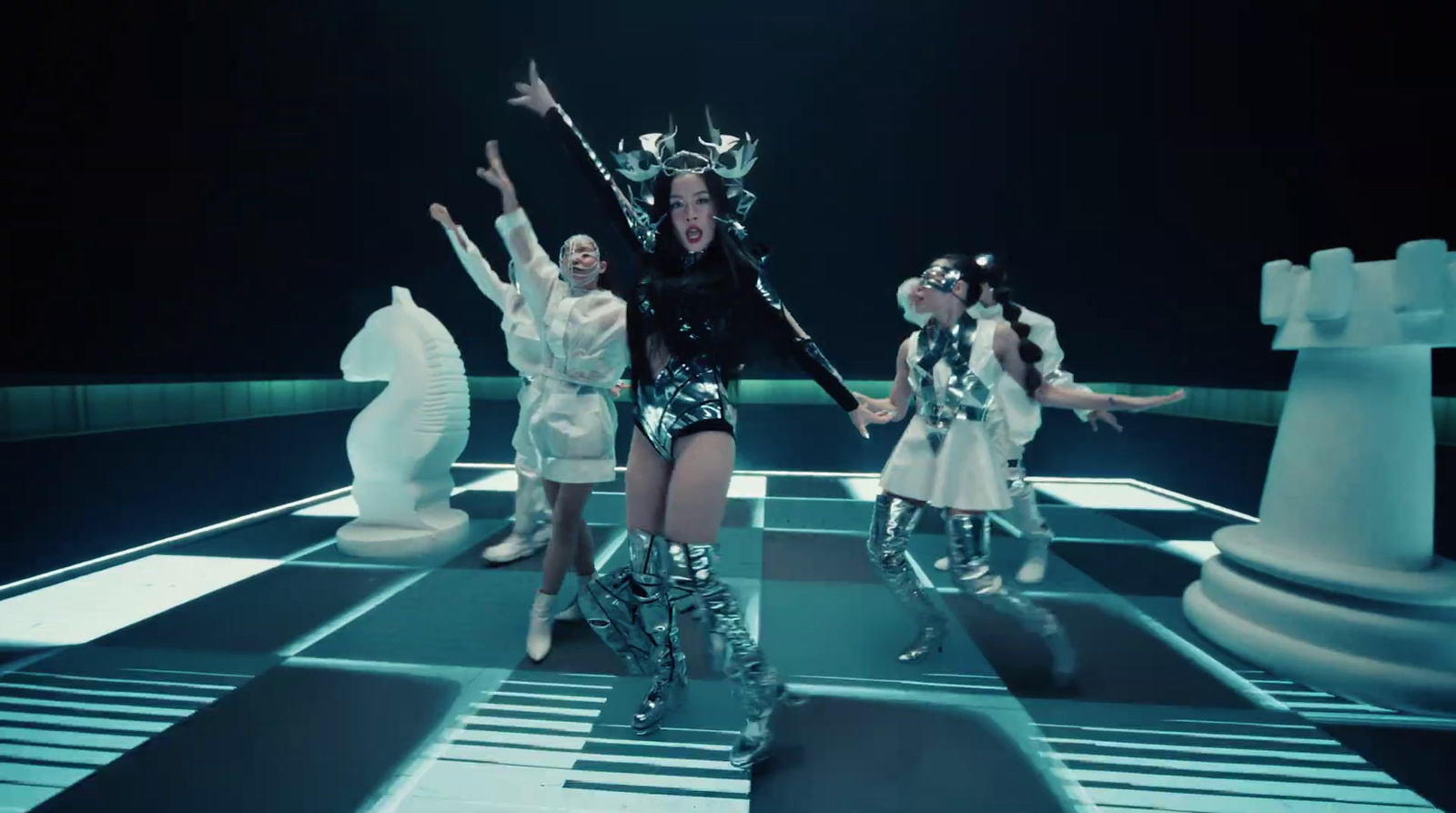 a group of women standing on top of a chess board