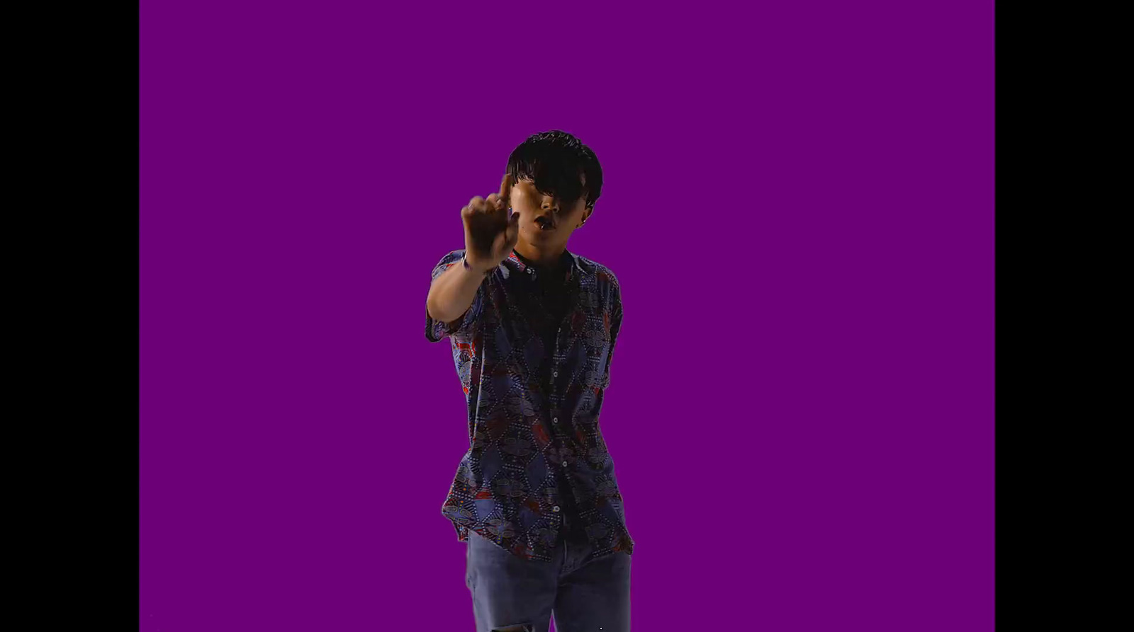 a man standing in front of a purple background