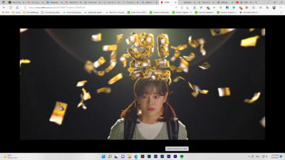 a screen shot of a woman with a bunch of gold numbers on her head