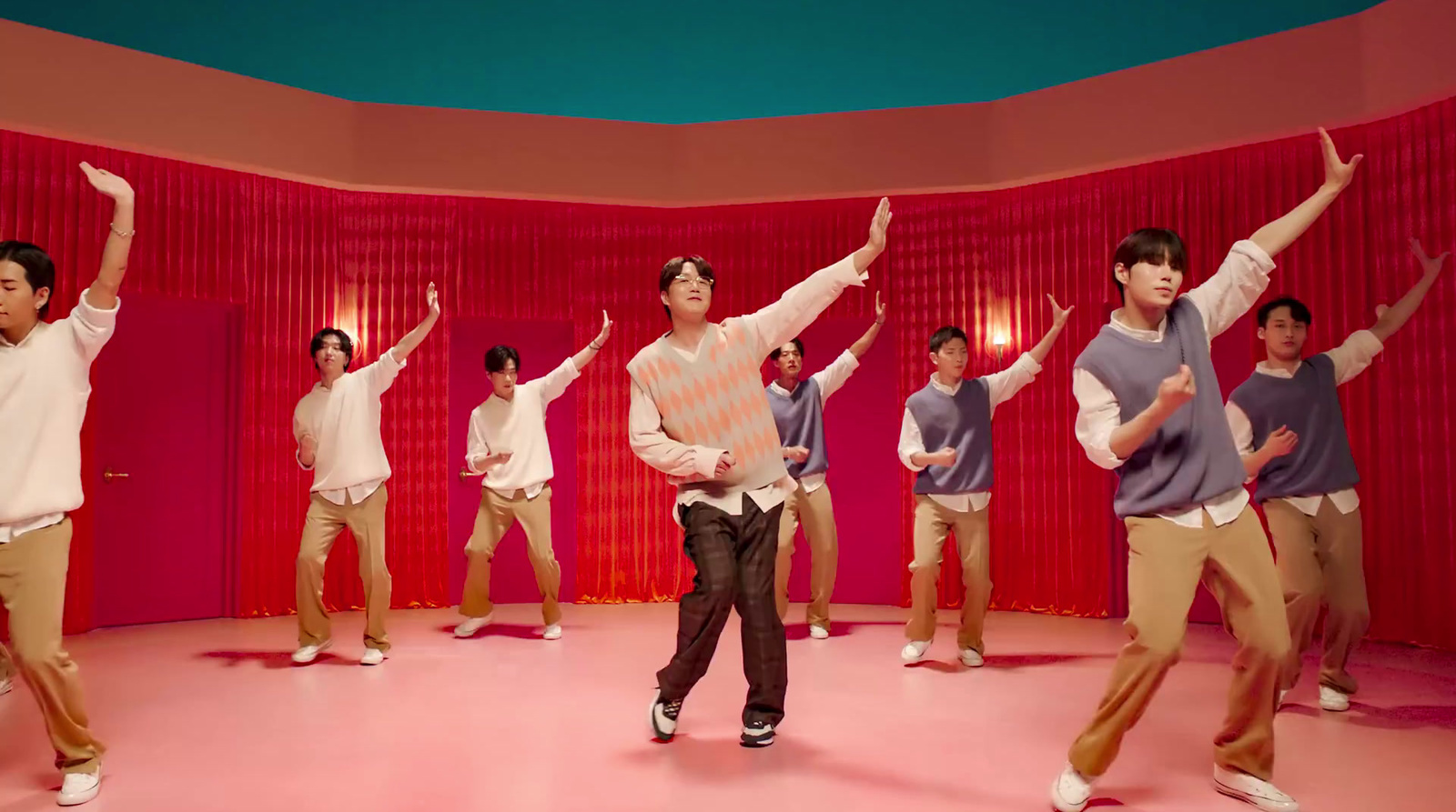 a group of young men standing on top of a pink floor