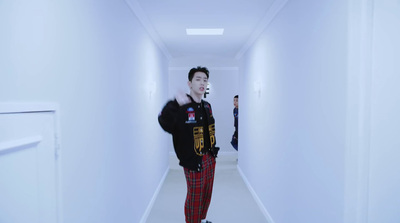 a man is walking down a long hallway