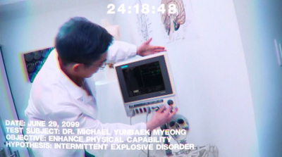 a man in a lab coat looking at a computer screen