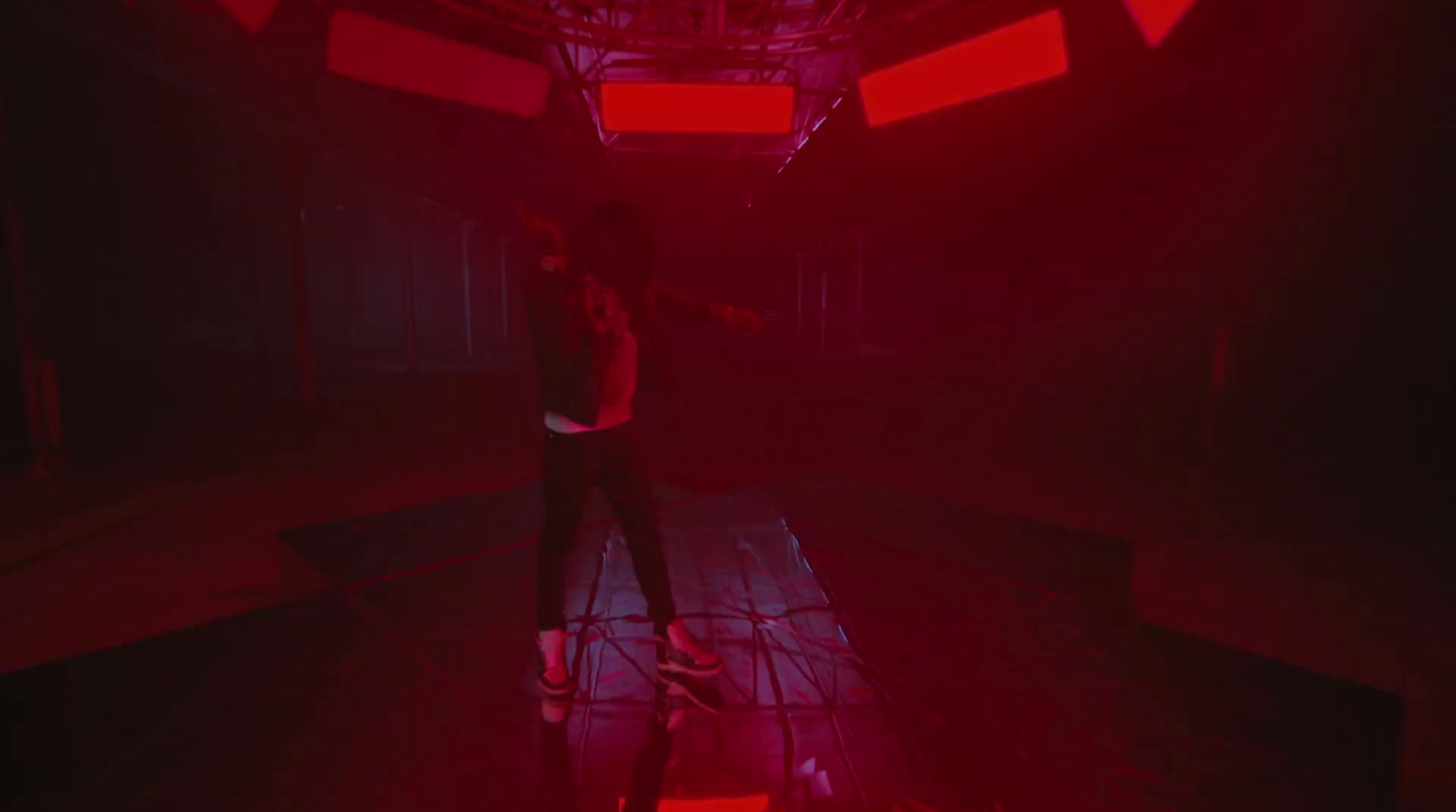 a person standing in a room with red lights